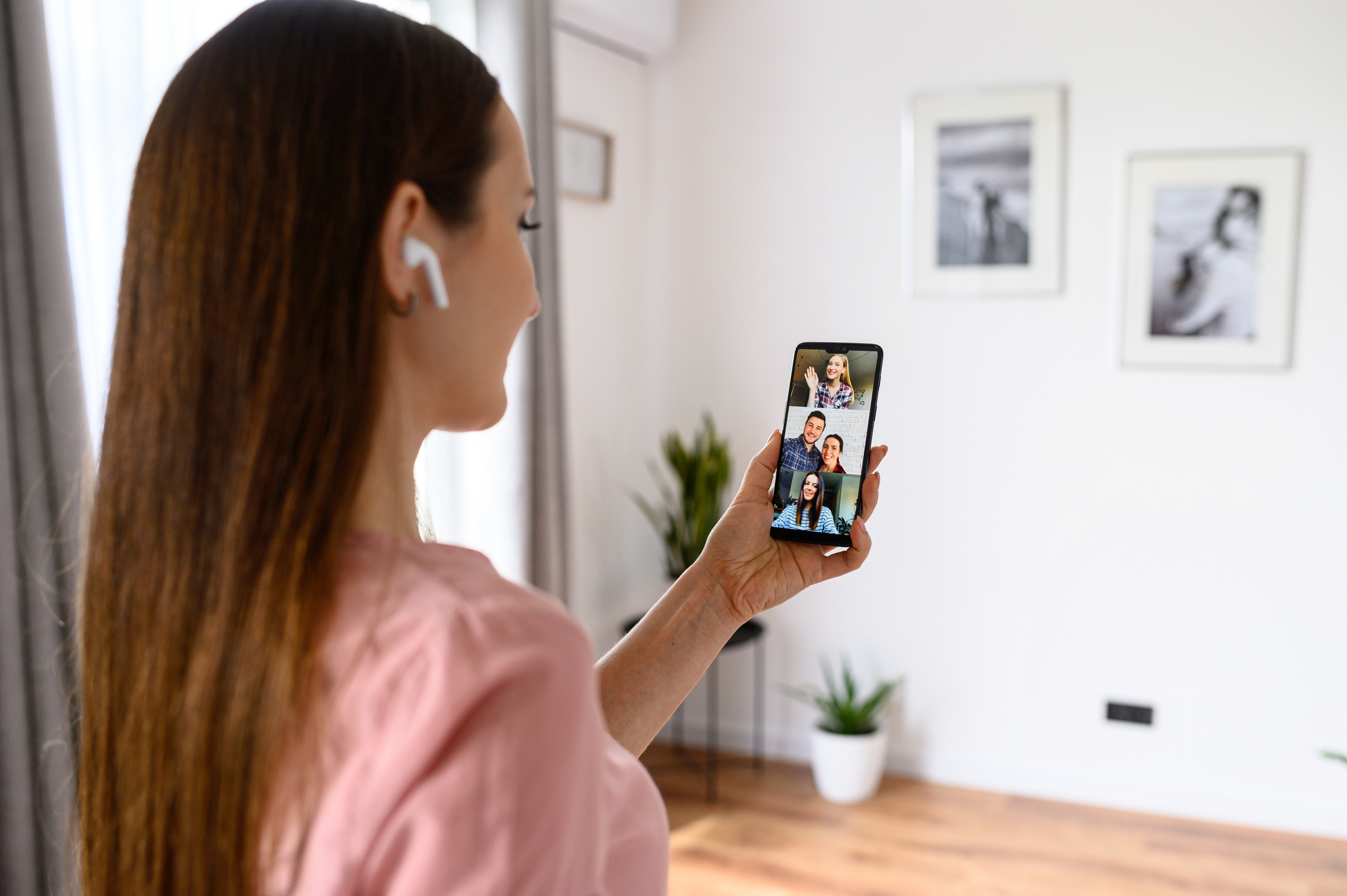 A young woman using phone for video call, zoom